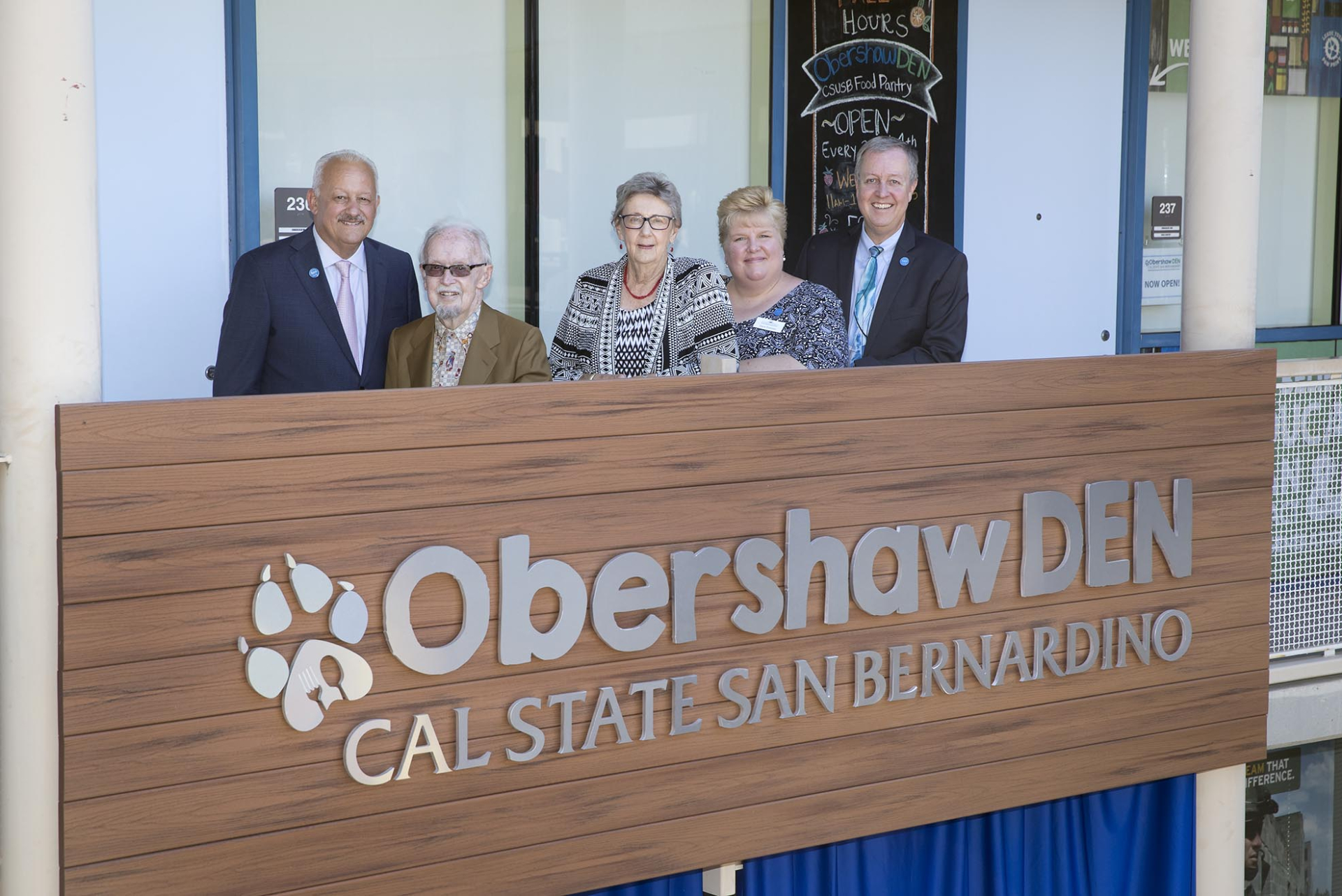 At the dedication ceremony for the Obershaw DEN Food Pantry, from left, President Tomás D. Morales; Charles Obershaw; Shelby Obershaw; Diane Podolske, then director, Office of Community Engagement; and Ron Fremont, then vice president, University Advancement.