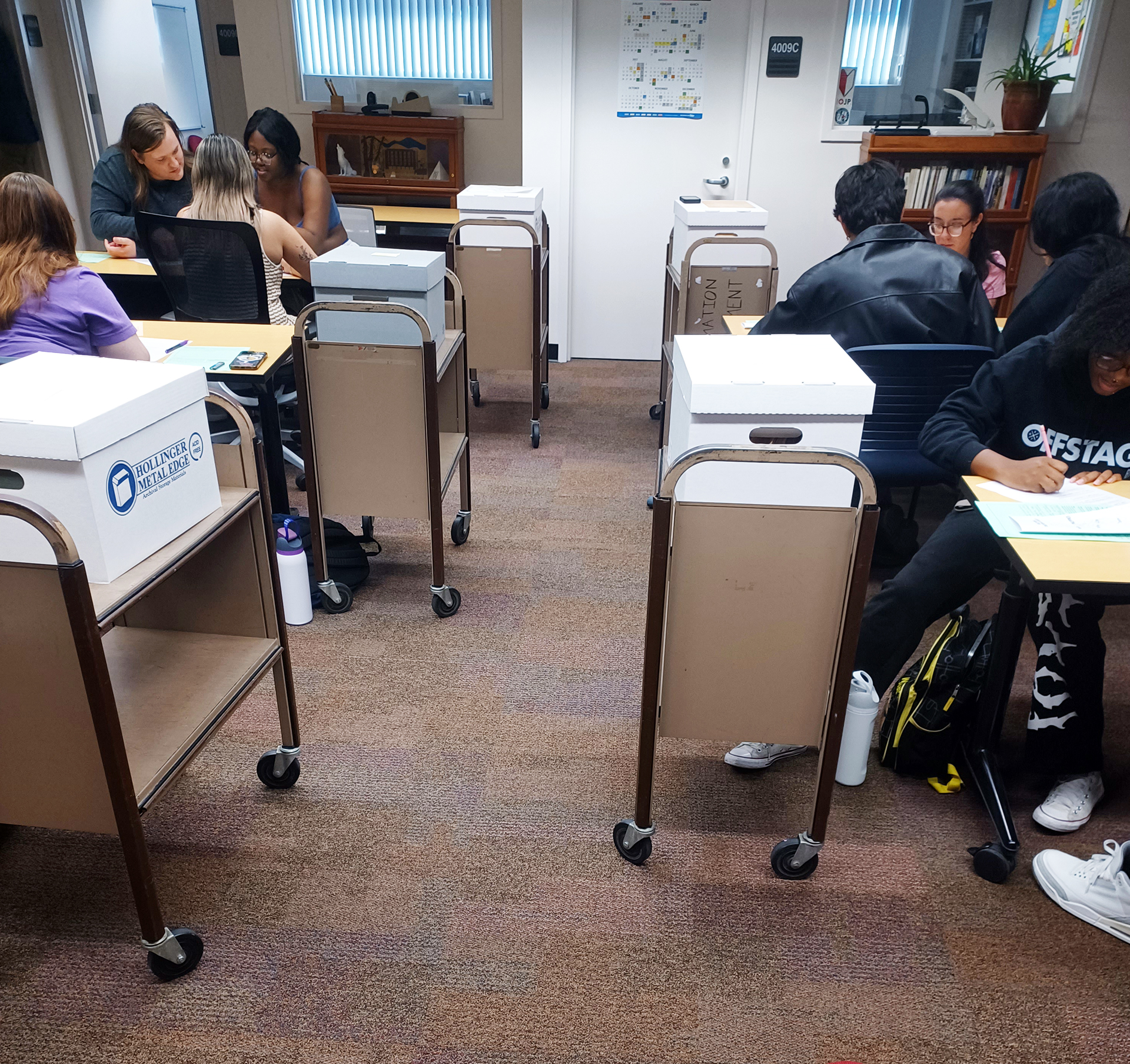 Students taking the history course, “Women in the Black Freedom Movement” (HIST 3460), look over materials as part of an archival project for the John M. Pfau Library’s Special Collections and University Archives.
