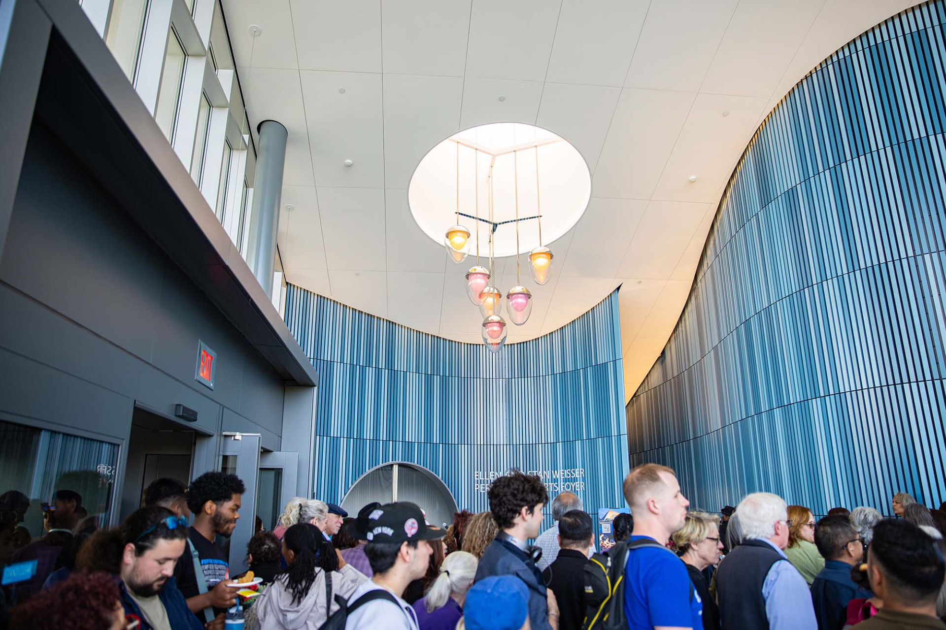 Guest make their way under the chandelier, created by Katherine Gray, glass artist and chair of the university’s Department of Art and Design, in the Ellen and Stan Weisser Foyer. 